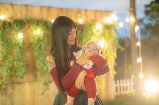 Parent and child portrait under Joyforest evening string lights
