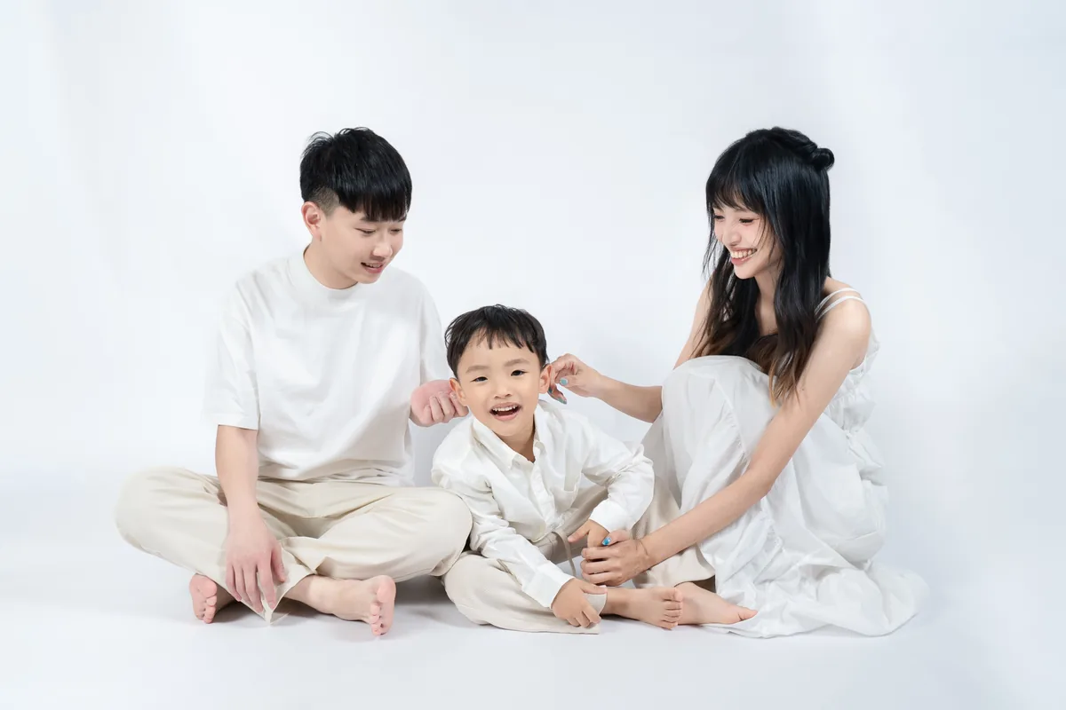 純白棚內背景中的親子全家福自然互動畫面